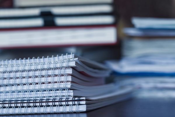 Accounting and taxes. Large pile of magazine, notebook and books closeup